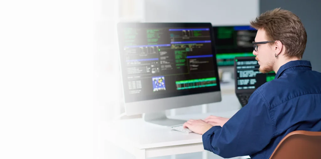 Security analyst reviewing code on monitors, cybersecurity services in Austin