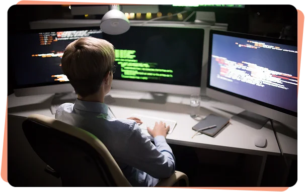 Security analyst monitoring code on several screens, cybersecurity services Cincinnati
