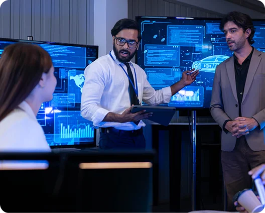 Security team reviewing threat dashboards on large screens in a security operations center