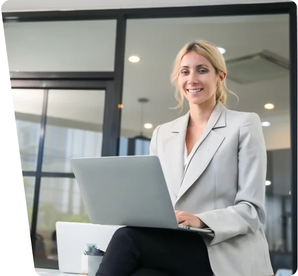 Smiling businesswoman working on a laptop, cybersecurity services in Cincinnati