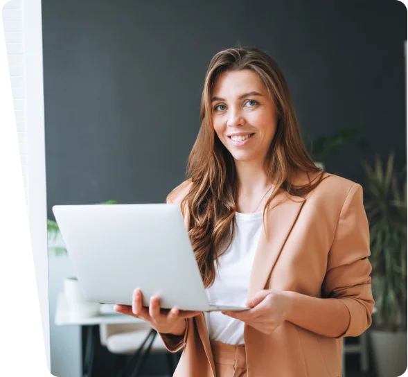 Smiling businesswoman holding a laptop in an office, cybersecurity services Honolulu